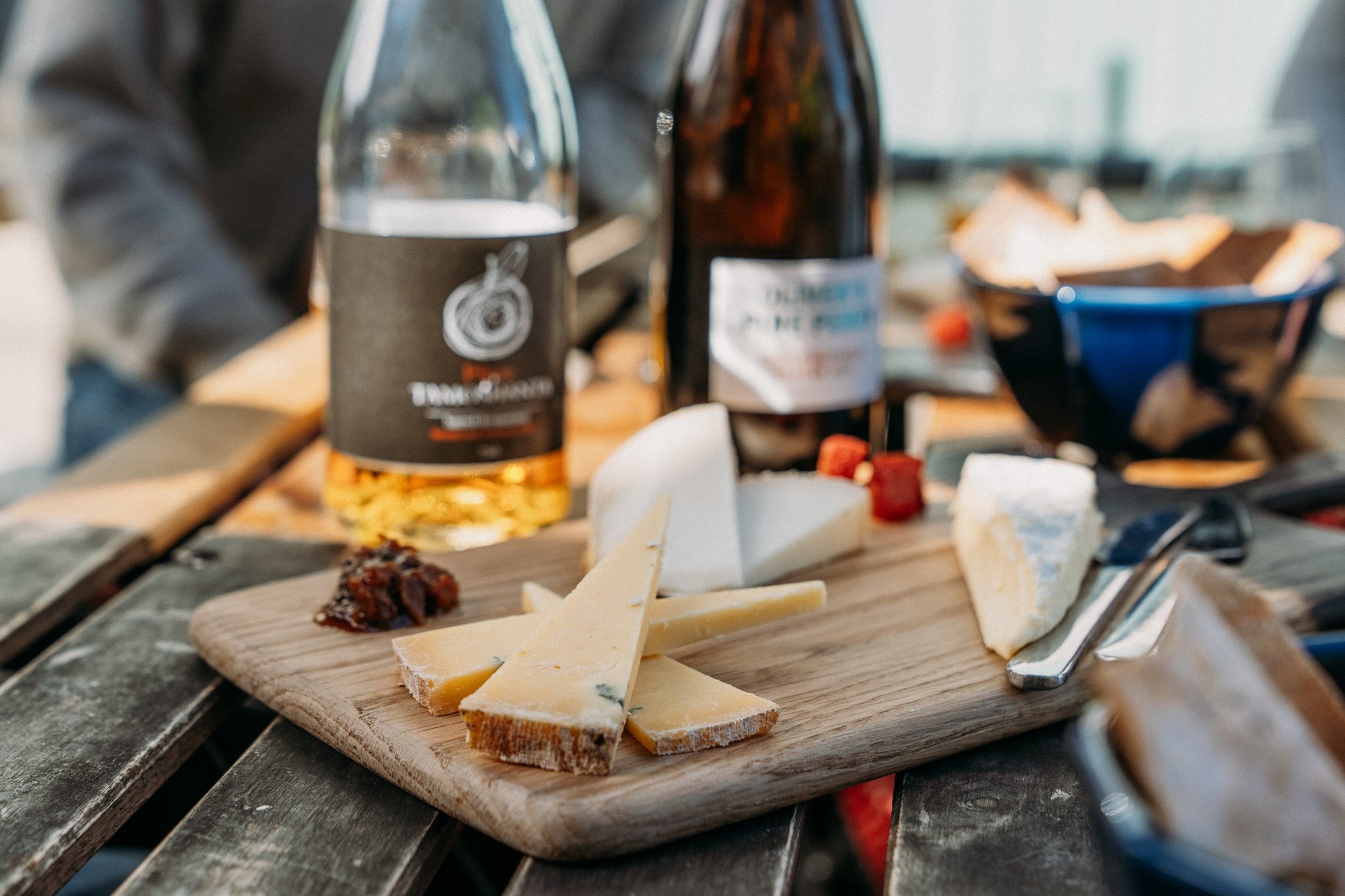a cheeseboard and some ciders